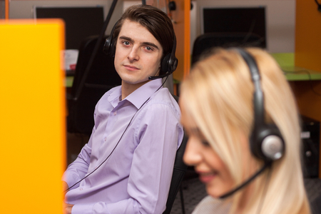 Portrait of call center agent at work in box officeの写真素材