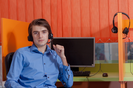 Portrait of call center agent at work in box officeの写真素材