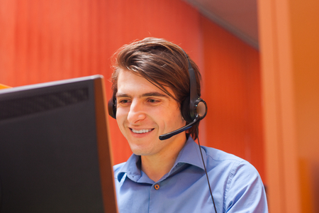 Portrait of call center agent at work in box officePortrait of call center agent at work in box officeの写真素材