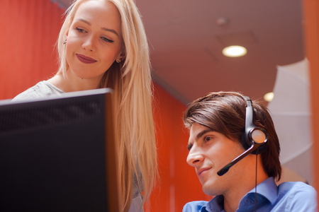 Portrait of call center agent at work in box officeの写真素材