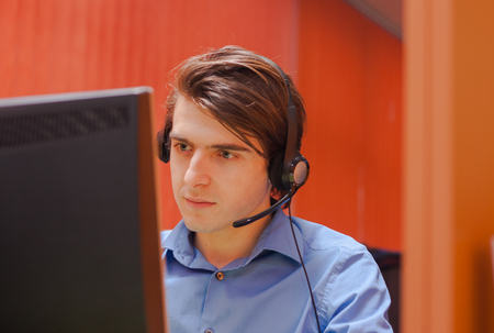 Portrait of call center agent at work in box officeの写真素材