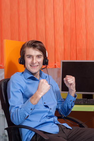 Portrait of call center agent at work in box officeの写真素材