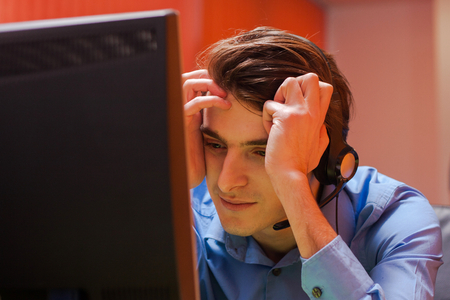 Portrait of call center agent at work in box officeの写真素材