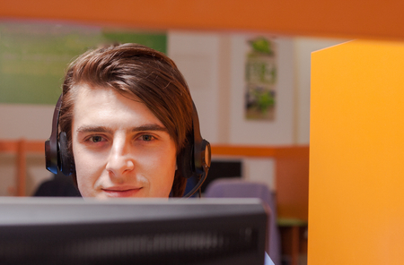 Portrait of call center agent at work in box officeの写真素材