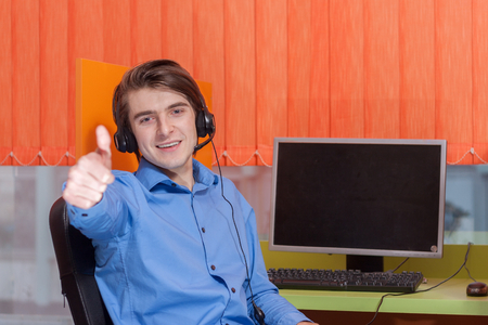 Portrait of call center agent at work in box officeの写真素材