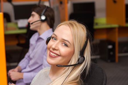 Portrait of call center agent at work in box officeの写真素材