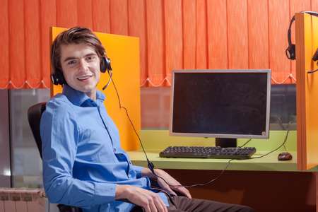 Portrait of call center agent at work in box officeの写真素材
