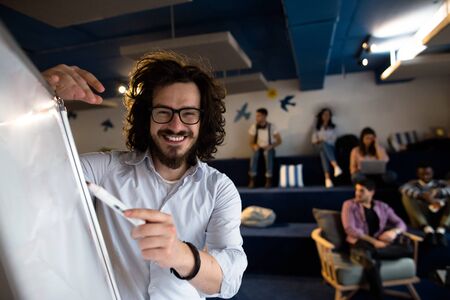 Young entrepreneurs are brainstorming ideas and working together in modern work environment.の写真素材