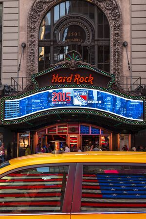 New York, USA - May 19 2015: American flag reflecting at Yellow New York taxi in front of the Hard Rock Cafe in Times Square, New York City, United States of America, North Americaのeditorial素材