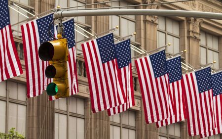 USA American Flags and yellow traffic light, New York, United States of America, North Americaの写真素材