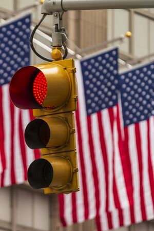 USA American Flags and yellow traffic light, New York, United States of America, North Americaの写真素材