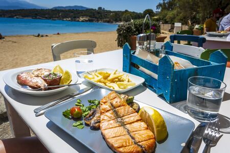 Grilled Salmon, fries and bread, Marathi Beach, Crete, Greek Islands Greece Europe