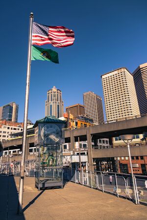 Seattle, USA - September 28 2017: United States of America and Washington State flag waving over the Colman Clock in Seattle, Washinton, USA.のeditorial素材