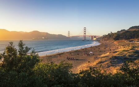 Sun sets near thr Golden Gate Bridge, Baker Beach, San Francisco, California, USAの写真素材
