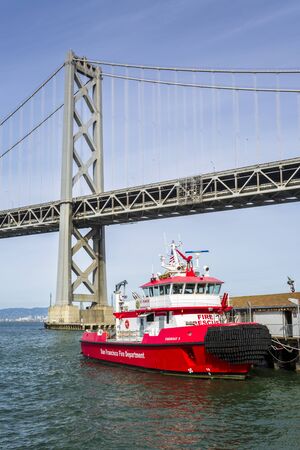 San Francisco, USA - June 9 2018: Oakland Bay Bridge and Fire Rescue Boat, San Francisco, California, United States of America, North Americaのeditorial素材