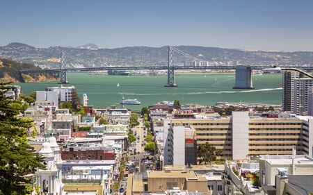 San Francisco, USA - June 11 2018: Street view with Oakland Bay bridge in the background, San Francisco, California, USA, North Americaのeditorial素材