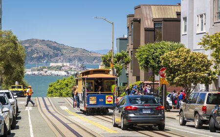 San Francisco, USA - June 11 2018: Cable Car with Alcatraz island in the background, San Francisco, California, USA, North Americaのeditorial素材
