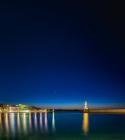 Illuminated Venetian Harbour and Lighthouse at night, Chania, Crete, Greek Islands, Greece, Europeの写真素材