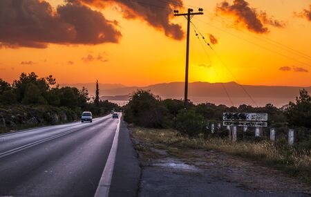 Crete, Greece - April 21 2018: Sunset over mountains and Aerodromiou Road, Crete, Greek Islands, Greece Europeaのeditorial素材