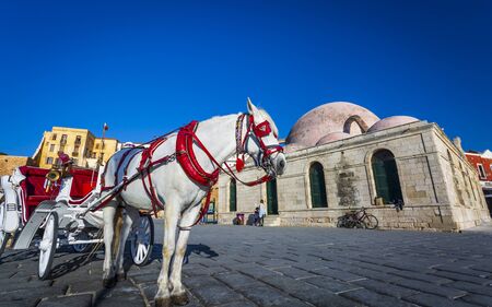 Crete, Greece - April 23 2018: Horse Carriage, Mosque, Venetian Harbour Chania Crete Greece Europeのeditorial素材