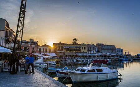 Crete, Greece - April 26 2018: Old Venetian harbour, taverns on seaside at sunset, Rethymno (Rethymnon), Crete, Greek Islands, Greece Europeのeditorial素材