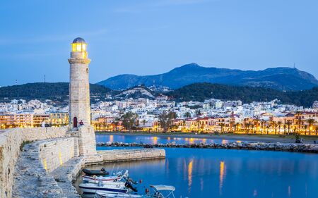 Crete, Greece - April 26 2018: Lighthouse at old Venetian harbour at dusk, Rethymno (Rethymnon), Crete, Greek Islands, Greece, Europeのeditorial素材
