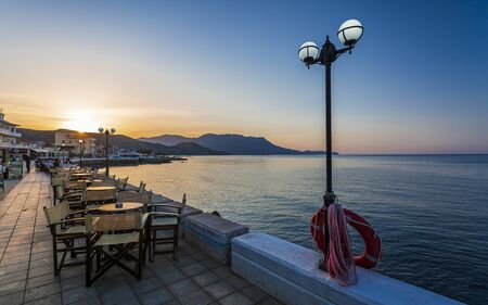 Crete, Greece - April 25 2018: Restaurant at Paraliaki promenaad at sunset in Kissamos, Crete, Greek Islands, Greece, Europeのeditorial素材