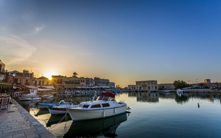Crete, Greece - April 26 2018: Old Venetian harbour, taverns on seaside at sunset, Rethymno (Rethymnon), Crete, Greek Islands, Greece Europeのeditorial素材