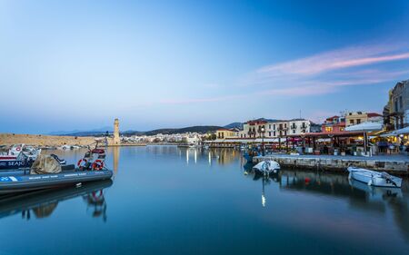 Old Venetian harbour, taverns on seaside at dusk, Rethymno (Rethymnon), Crete, Greek Islands, Greece, Europeの写真素材