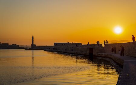 Crete, Greece - April 27 2018: Dusk light over the harbour and the lighthouse silhouetted on the horizon, Chania, Crete, Greece, Europeのeditorial素材