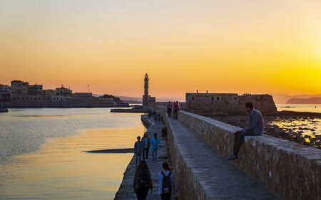 Crete, Greece - April 27 2018: Dusk light over the harbour and the lighthouse silhouetted on the horizon, Chania, Crete, Greece, Europeのeditorial素材