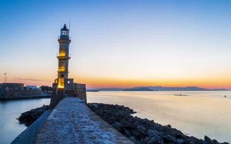 The lighthouse at the Venecian harbour of Chania at dusk, Chania, Crete, Greek Islands, Greece, Europeの写真素材