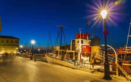 Crete, Greece - April 28 2018: Fishing boat at The Venetian Harbour at night, Chania, Crete, Greek Islands, Greece, Europeのeditorial素材