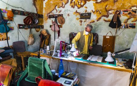 Man gluing leather, Chania, Crete, Greek Islands Greece Europeのeditorial素材