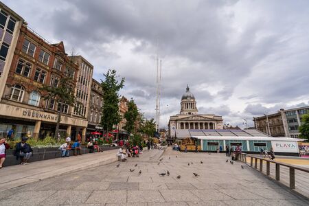 NOTTINGHAM, UK - AUGUST 07, 2019: Council House (City Hall) at Old Market Square with a pool, fountain, sand and beach chairs in the foreground.のeditorial素材
