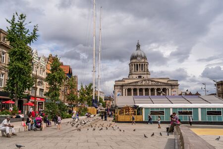NOTTINGHAM, UK - AUGUST 07, 2019: Council House (City Hall) at Old Market Square with a pool, fountain, sand and beach chairs in the foreground.のeditorial素材