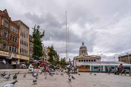 NOTTINGHAM, UK - AUGUST 07, 2019: Council House (City Hall) at Old Market Square with a pool, fountain, sand and beach chairs in the foreground.のeditorial素材