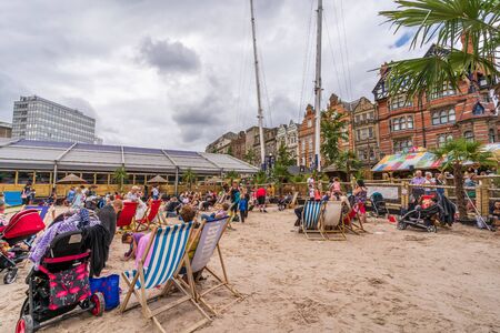 NOTTINGHAM, UK - AUGUST 07, 2019: Council House (City Hall) at Old Market Square with a pool, fountain, sand and beach chairs in the foreground.のeditorial素材