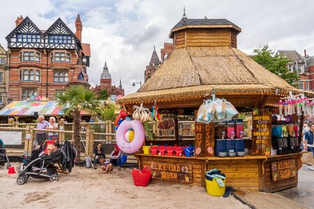 NOTTINGHAM, UK - AUGUST 07, 2019: Council House (City Hall) at Old Market Square with a pool, fountain, sand and beach chairs in the foreground.のeditorial素材
