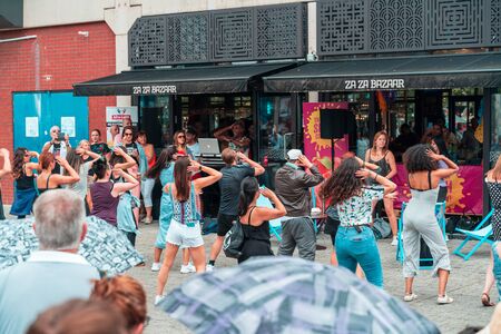 BRISTOL, ENGLAND - JULY 21, 2019: People dancing outside the restaurant at the Harbour Festival in Bristol, Englandのeditorial素材
