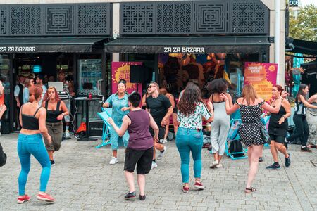 BRISTOL, ENGLAND - JULY 21, 2019: People dancing outside the restaurant at the Harbour Festival in Bristol, Englandのeditorial素材