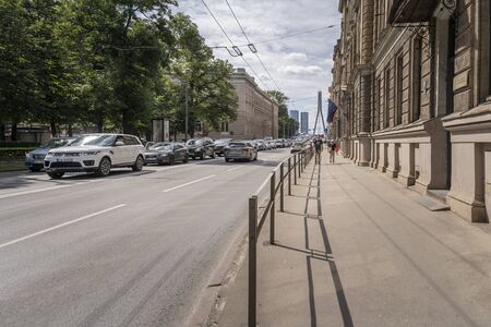 RIGA, LATVIA - AUGUST 16, 2019: Suspension bridge - Vansu Tilts - with skyscrapers in the background, Riga, Latvia, Europeのeditorial素材