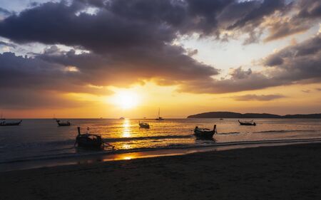 Krabi, Thailand - DECEMBER 24, 2019: Long tail boats at sunset on Railay beach in Railay, Ao Nang, Krabi Province, Thailand, Southeast Asia, Asiaのeditorial素材