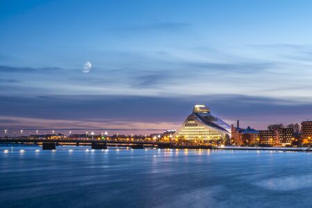 Latvian National Library at night and river Daugavaの写真素材
