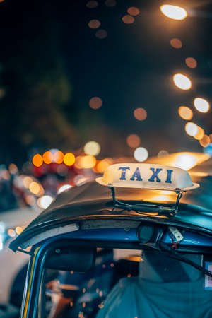 Chiang Mai, Thailand - Decemer 31st, 2019: Nightlife in Chiang Mai, a tuk tuk in the street, Chiang...