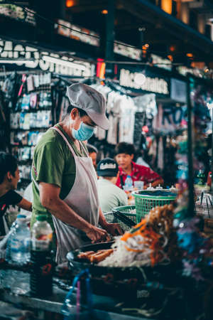 Bangkok, Thailand - December 18th 2019: Bangkok street market at night, food, flowers, face mask, Thailand, SouthEast Asiaのeditorial素材
