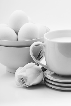 Coffee cup and eggs on a white background. white on white styleの写真素材