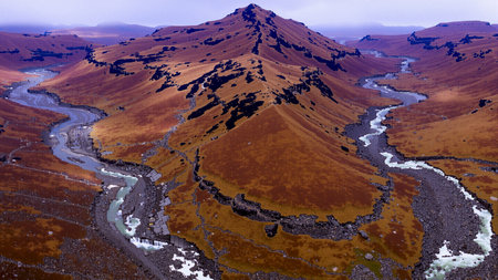 Aerial view of volcanic landscape with river and mountainsの素材