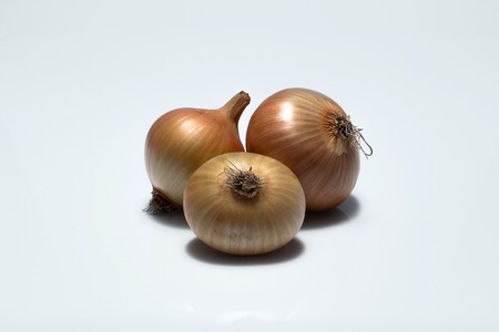 fresh onions close up on an isolated backgroundの写真素材