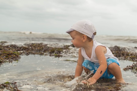 boy playing on the beachの写真素材